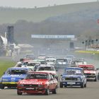 The Group 1 Touring Car field heads into the first corner at the 2014 Goodwood Member's Meeting