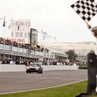 Guido van der Garde takes the flag at the end of the 2014 Goodwood Revival TT Celebration race