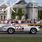 Sir Stirling Moss roars past Goodwood House in a Mercedes-Benz 300 SLR